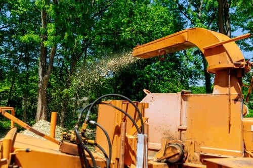 Wood chipper discharging chips during a tree service job in Litchfield County, Connecticut