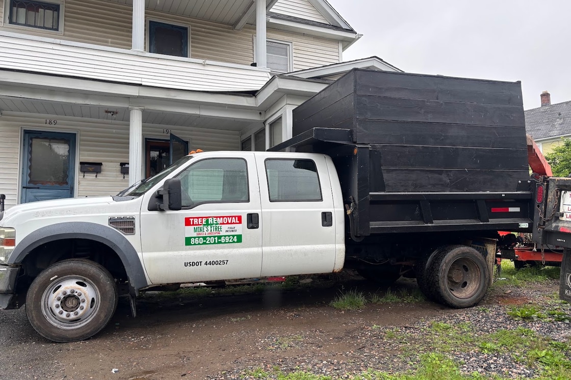 Mike's Tree Service tree removal truck with chip body at a home in Torrington CT